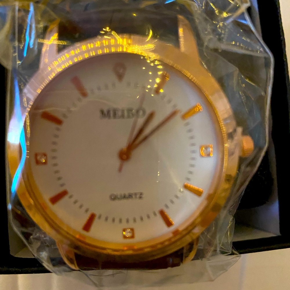 Men’s Goldtone watch with brown watch band
